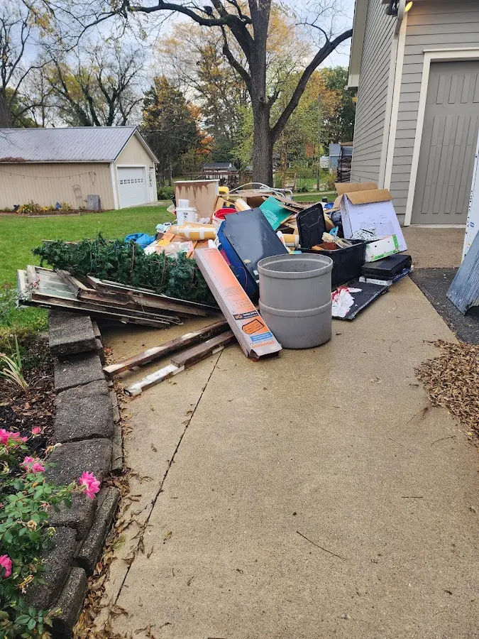 Dumpster being loaded with debris for Estate Cleanout Dumpster Rental in Anthony
